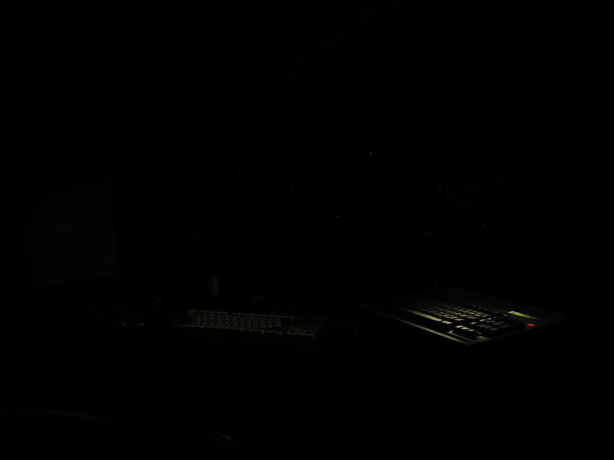 Dark workspace lit by a single screen